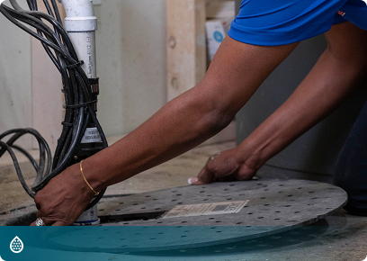 Drain services: Academy Air technician opening a basement floor drain