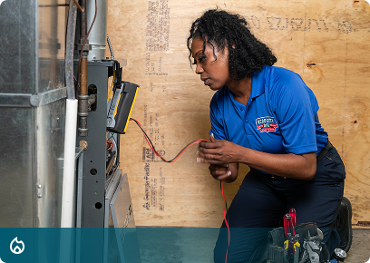 Heating services: Academy Air technician testing wiring at a furnace