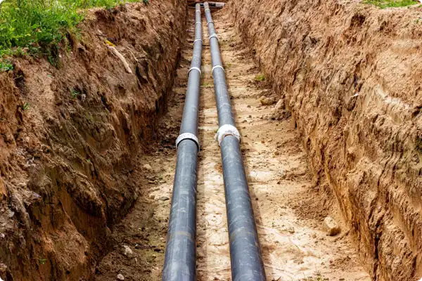 Two sewer lines laid side by side in an open trench